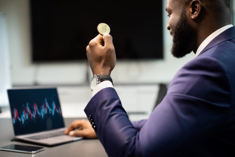 A man holding a bitcoin